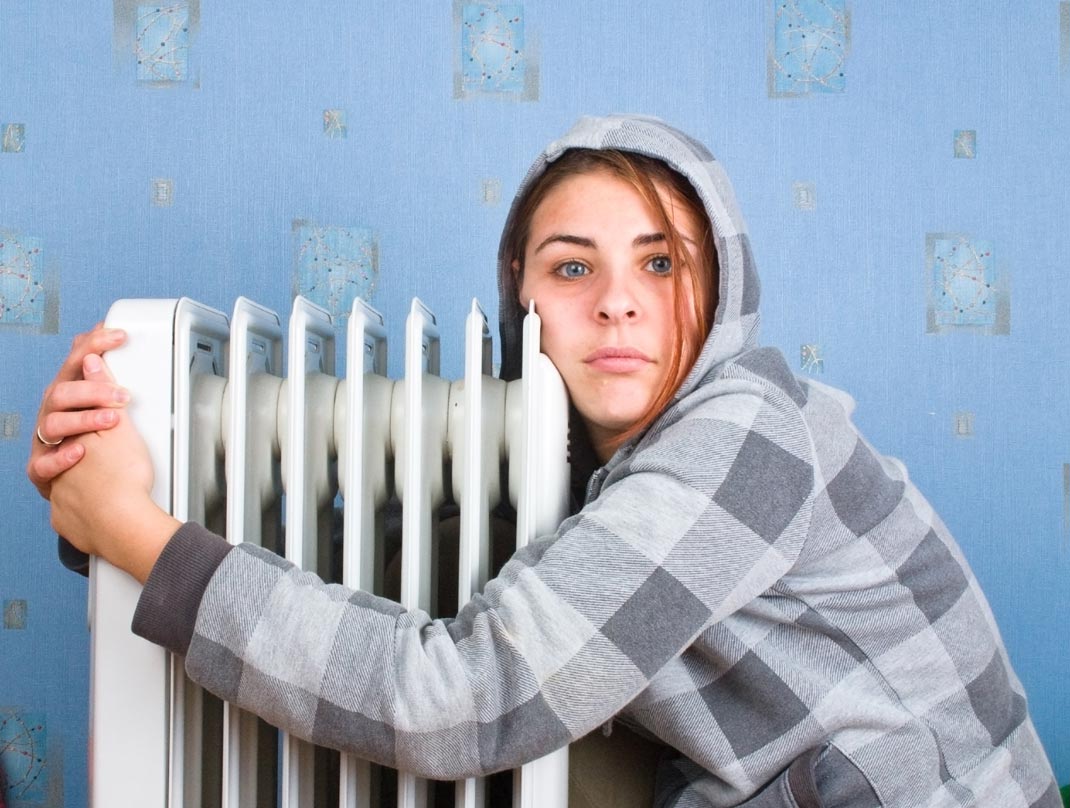 girl hugging heater